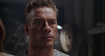 Movie still from “Universal Soldier: The Return” (1999), directed by Mic Rodgers – A person wearing a white t - shirt; Close Up shot, Low angle