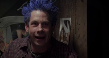 Movie still from “Universal Soldier: The Return” (1999), directed by Mic Rodgers – A man with blue hair is smiling for the camera; Close Up shot, Low angle
