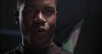 Movie still from “Universal Soldier: The Return” (1999), directed by Mic Rodgers – A man's face in a dark room; Close Up shot, Low angle