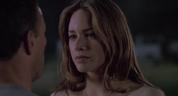 Movie still from “Universal Soldier: The Return” (1999), directed by Mic Rodgers – A person with long brown hair; Close Up shot, Over the shoulder angle