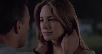 Movie still from “Universal Soldier: The Return” (1999), directed by Mic Rodgers – A man and a woman holding each other's neck; Close Up shot, Over the shoulder angle