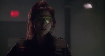 Movie still from “Universal Soldier: The Return” (1999), directed by Mic Rodgers – A woman with red hair wearing goggles and a jacket; Close Up shot, Low angle