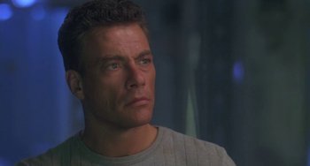Movie still from “Universal Soldier: The Return” (1999), directed by Mic Rodgers – A person wearing a gray shirt; Close Up shot, Low angle