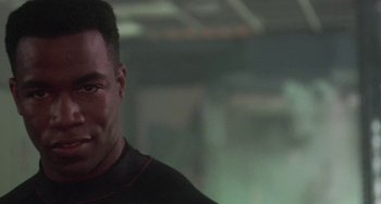 Movie still from “Universal Soldier: The Return” (1999), directed by Mic Rodgers – A person wearing a black shirt; Close Up shot, Low angle