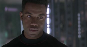 Movie still from “Universal Soldier: The Return” (1999), directed by Mic Rodgers – A person wearing a black shirt; Close Up shot, Over the shoulder angle