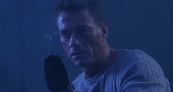 Movie still from “Universal Soldier: The Return” (1999), directed by Mic Rodgers – A person holding a cell phone; Close Up shot, Low angle