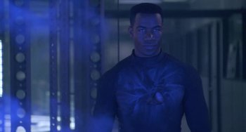 Movie still from “Universal Soldier: The Return” (1999), directed by Mic Rodgers – A man standing in front of a blue light; Medium shot, Over the shoulder angle