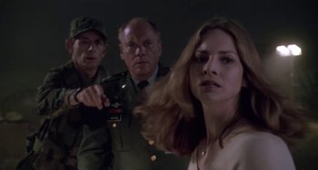 Movie still from “Universal Soldier: The Return” (1999), directed by Mic Rodgers – A group of men and a woman standing next to each other; Medium shot, Low angle