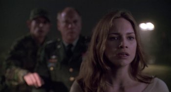 Movie still from “Universal Soldier: The Return” (1999), directed by Mic Rodgers – A group of people standing next to each other in a room; Close Up shot, Over the shoulder angle