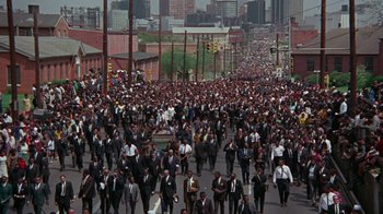 Movie still from “Uptight” (1968), directed by Jules Dassin – A large group of people walking down a street; Extreme Wide shot, High angle