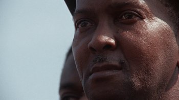Movie still from “Uptight” (1968), directed by Jules Dassin – A man's eyes and face; Extreme Close Up shot, Low angle