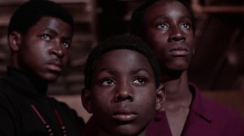 Movie still from “Uptight” (1968), directed by Jules Dassin – A group of young men standing next to each other; Close Up shot, Low angle