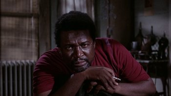 Movie still from “Uptight” (1968), directed by Jules Dassin – A man with a cigarette in his mouth; Close Up shot, Low angle