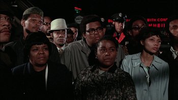 Movie still from “Uptight” (1968), directed by Jules Dassin – A group of people standing in front of a traffic light; Medium shot, Low angle
