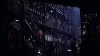 Movie still from “Uptight” (1968), directed by Jules Dassin – A group of people standing in a building with stairs; Extreme Wide shot, High angle