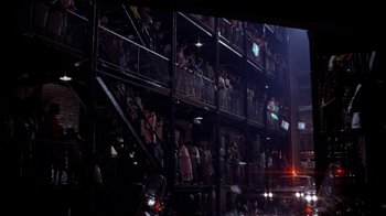 Movie still from “Uptight” (1968), directed by Jules Dassin – A group of people standing in a building with stairs; Extreme Wide shot, Low angle