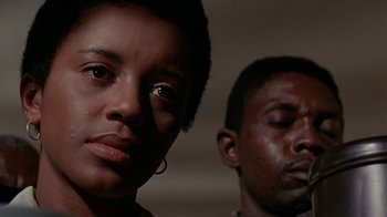 Movie still from “Uptight” (1968), directed by Jules Dassin – A woman and a man are standing next to each other; Close Up shot, Low angle