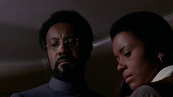 Movie still from “Uptight” (1968), directed by Jules Dassin – A man and a woman standing next to each other; Close Up shot, Low angle