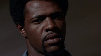 Movie still from “Uptight” (1968), directed by Jules Dassin – A person with a beard; Close Up shot, Low angle