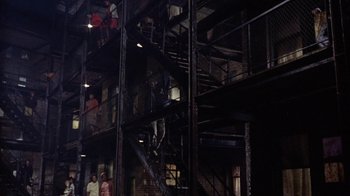 Movie still from “Uptight” (1968), directed by Jules Dassin – A group of people standing on top of a fire escape; Extreme Wide shot, High angle