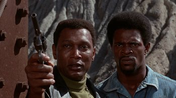 Movie still from “Uptight” (1968), directed by Jules Dassin – Two black men standing next to each other holding a gun; Close Up shot, Low angle