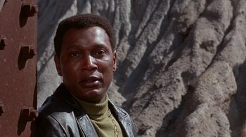 Movie still from “Uptight” (1968), directed by Jules Dassin – A person wearing a leather jacket; Close Up shot, Low angle