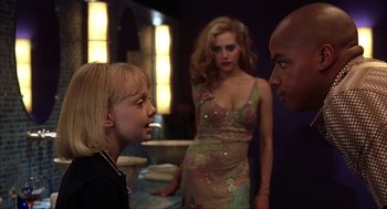 Movie still from “Uptown Girls” (2003), directed by Boaz Yakin – Two women and a man are talking in a room; Medium shot, Over the shoulder angle