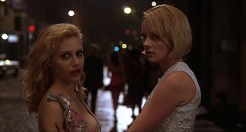 Movie still from “Uptown Girls” (2003), directed by Boaz Yakin – Two women standing next to each other on a sidewalk; Close Up shot, Over the shoulder angle