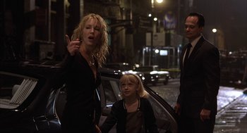Movie still from “Uptown Girls” (2003), directed by Boaz Yakin – A woman standing next to a child and a car; Medium shot, Over the shoulder angle