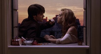 Movie still from “Uptown Girls” (2003), directed by Boaz Yakin – A man and a woman sitting at a table; Medium shot, Overhead angle