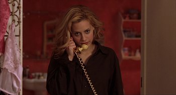 Movie still from “Uptown Girls” (2003), directed by Boaz Yakin – A woman talking on a phone while wearing a black shirt; Close Up shot, High angle