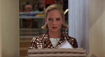 Movie still from “Uptown Girls” (2003), directed by Boaz Yakin – A woman with blonde hair wearing a checkered jacket; Medium shot, Over the shoulder angle
