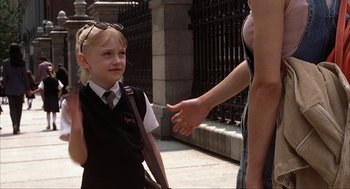 Movie still from “Uptown Girls” (2003), directed by Boaz Yakin – A little girl in a school uniform is talking to a woman; Medium shot, Over the shoulder angle