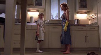 Movie still from “Uptown Girls” (2003), directed by Boaz Yakin – Two people standing in a kitchen next to each other; Medium shot, Low angle