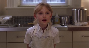Movie still from “Uptown Girls” (2003), directed by Boaz Yakin – A young girl wearing an apron in a kitchen; Close Up shot, Low angle