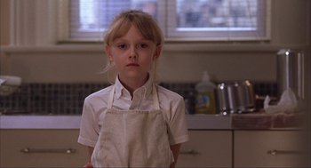 Movie still from “Uptown Girls” (2003), directed by Boaz Yakin – A little girl wearing an apron in a kitchen; Close Up shot, Low angle