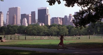 Movie still from “Uptown Girls” (2003), directed by Boaz Yakin – A woman walking in a park with a city skyline in the background; Extreme Wide shot, High angle