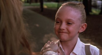 Movie still from “Uptown Girls” (2003), directed by Boaz Yakin – A young girl holding her hand out to the camera; Close Up shot, Over the shoulder angle