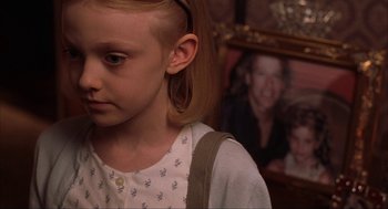 Movie still from “Uptown Girls” (2003), directed by Boaz Yakin – A young girl is looking down at a picture; Close Up shot, Over the shoulder angle