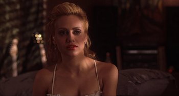 Movie still from “Uptown Girls” (2003), directed by Boaz Yakin – A beautiful woman sitting on a couch in a room; Close Up shot, Over the shoulder angle
