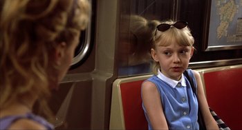 Movie still from “Uptown Girls” (2003), directed by Boaz Yakin – A little girl sitting on a seat on a train; Close Up shot, Over the shoulder angle