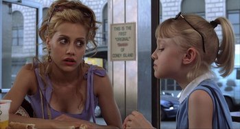 Movie still from “Uptown Girls” (2003), directed by Boaz Yakin – Two young people sitting at a table in front of each other; Close Up shot, Over the shoulder angle