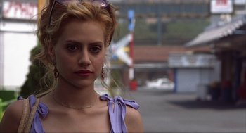 Movie still from “Uptown Girls” (2003), directed by Boaz Yakin – A young woman wearing a purple dress and a purple bow; Close Up shot, Over the shoulder angle
