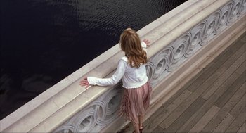 Movie still from “Uptown Girls” (2003), directed by Boaz Yakin – A little girl standing on a bridge looking over the edge of the water; Wide shot, High angle