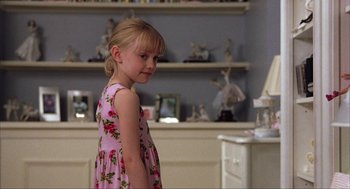 Movie still from “Uptown Girls” (2003), directed by Boaz Yakin – A little girl in a pink dress standing in a room; Medium shot, Over the shoulder angle