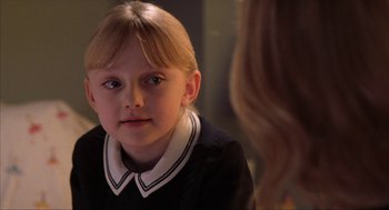 Movie still from “Uptown Girls” (2003), directed by Boaz Yakin – A little girl with blonde hair wearing a school uniform; Close Up shot, Over the shoulder angle