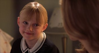 Movie still from “Uptown Girls” (2003), directed by Boaz Yakin – A young girl looking into a mirror and smiling; Close Up shot, Over the shoulder angle
