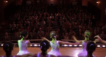 Movie still from “Uptown Girls” (2003), directed by Boaz Yakin – Three young ballerinas performing on stage in front of an audience; Wide shot, High angle