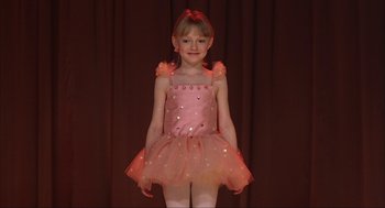 Movie still from “Uptown Girls” (2003), directed by Boaz Yakin – A little girl wearing a pink dress and white tights; Medium shot, High angle