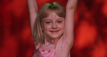 Movie still from “Uptown Girls” (2003), directed by Boaz Yakin – A little girl in a pink dress with her arms up; Close Up shot, Low angle